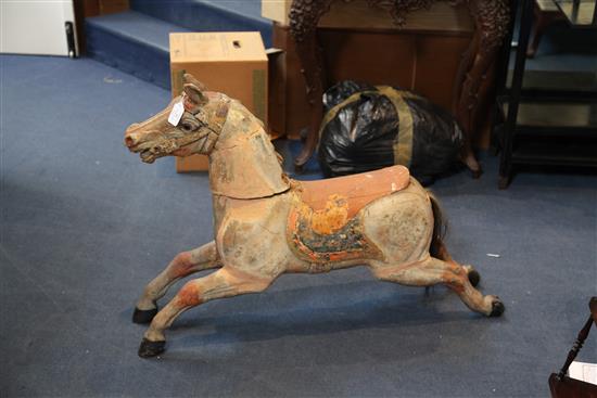 An early 20th century carved and painted wood carousel horse, W.39in. H.27in.